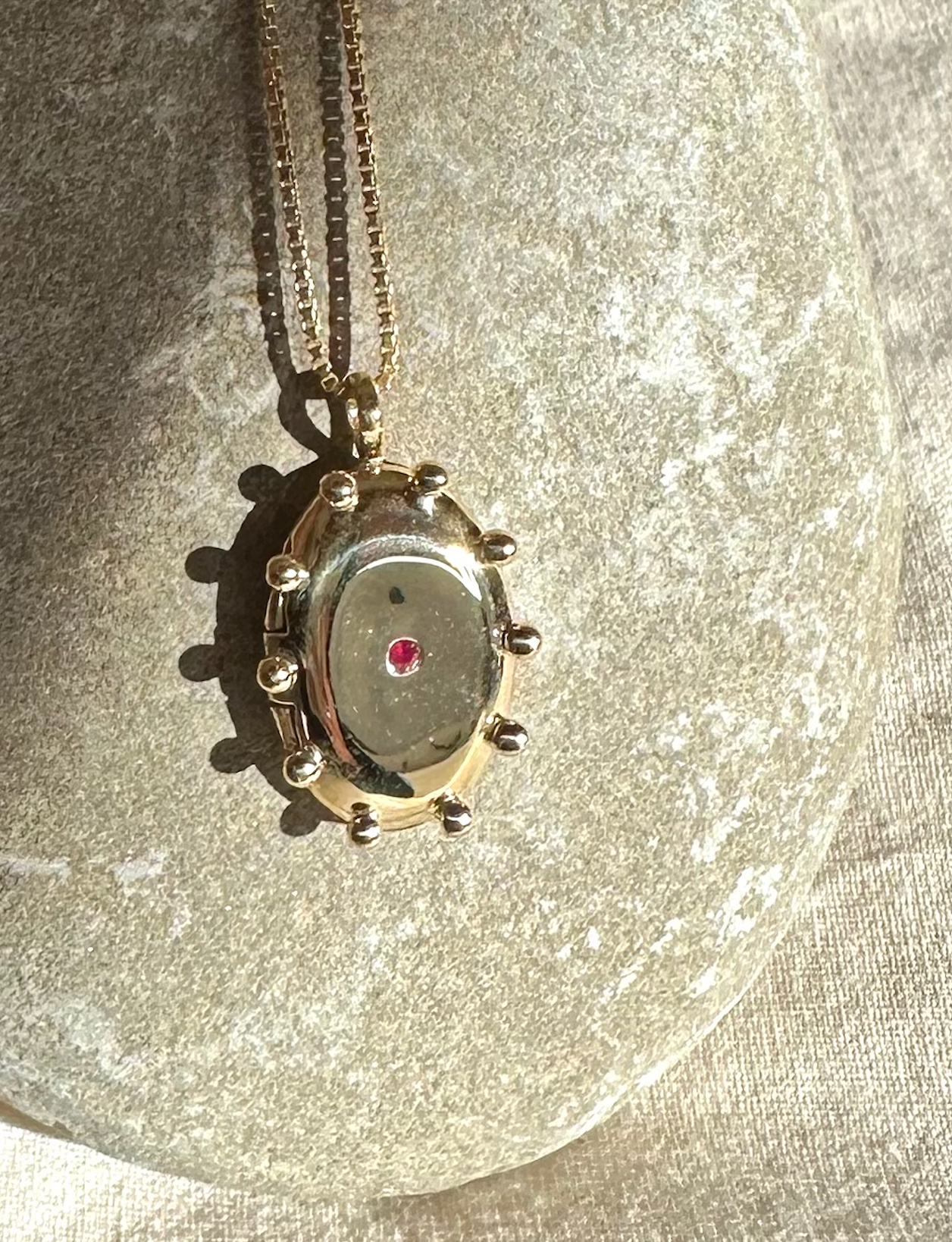 THE SUN locket with ruby