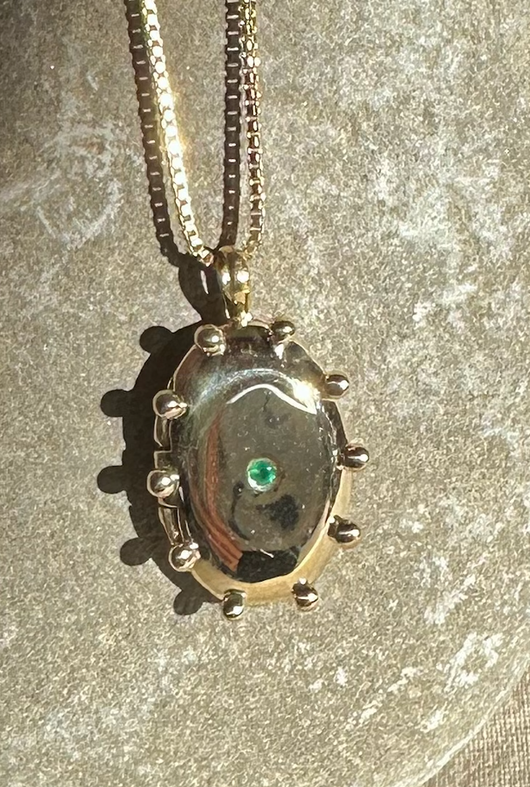 THE SUN locket with emerald